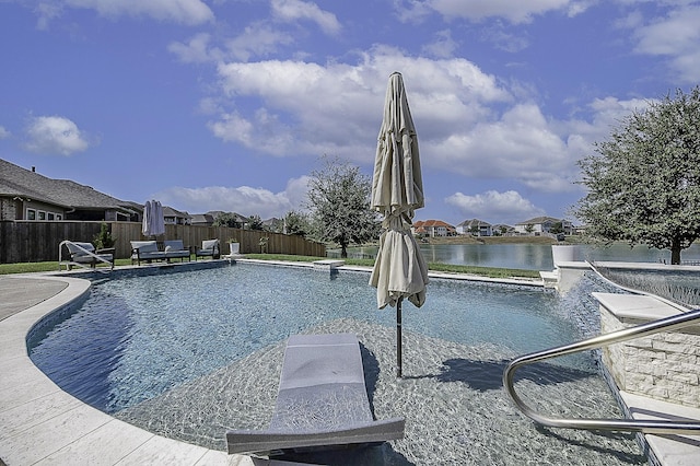 view of swimming pool featuring a water view