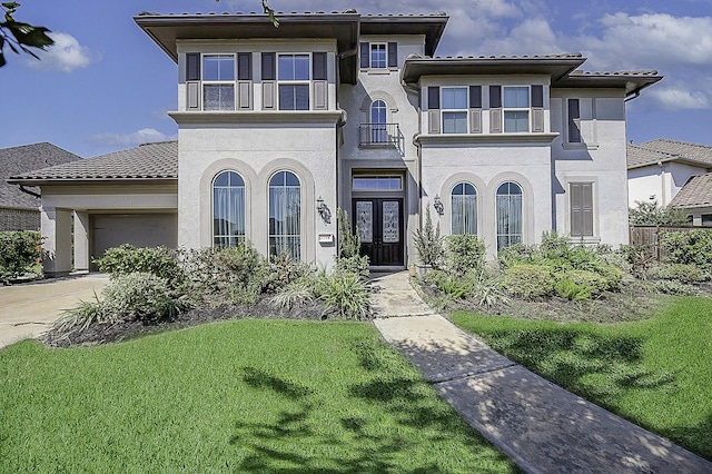 view of front of property featuring french doors and a front lawn