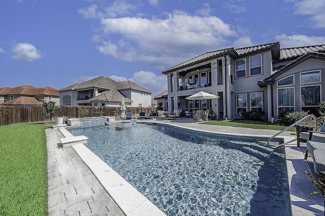 view of pool with a yard