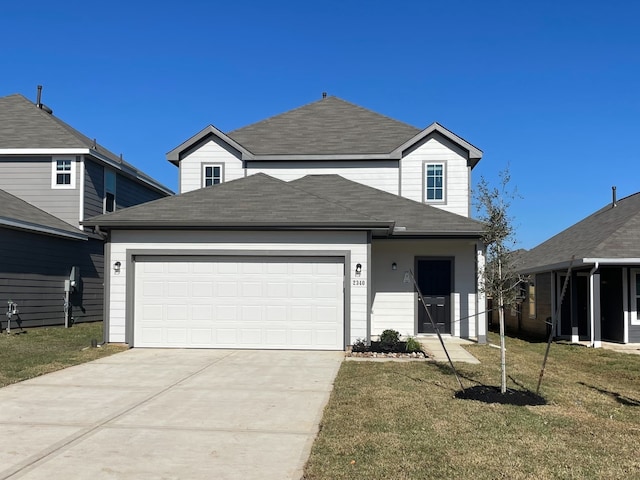 front of property featuring a front lawn and a garage