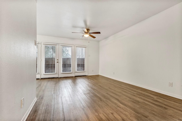 empty room featuring ceiling fan, french doors, and dark hardwood / wood-style floors