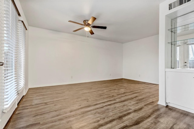 unfurnished living room featuring hardwood / wood-style flooring and ceiling fan