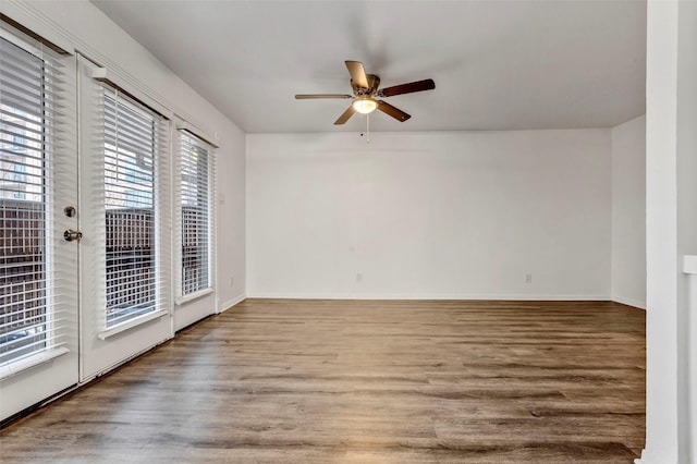 spare room with hardwood / wood-style floors, ceiling fan, and a healthy amount of sunlight