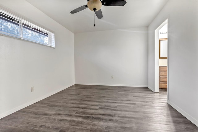 spare room featuring ceiling fan and dark wood-type flooring