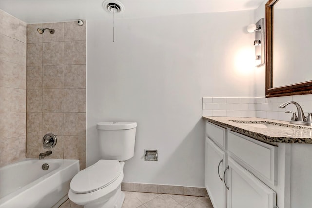 full bathroom featuring tiled shower / bath combo, tile patterned floors, toilet, decorative backsplash, and vanity