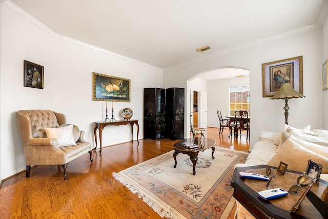 living room with crown molding and hardwood / wood-style flooring