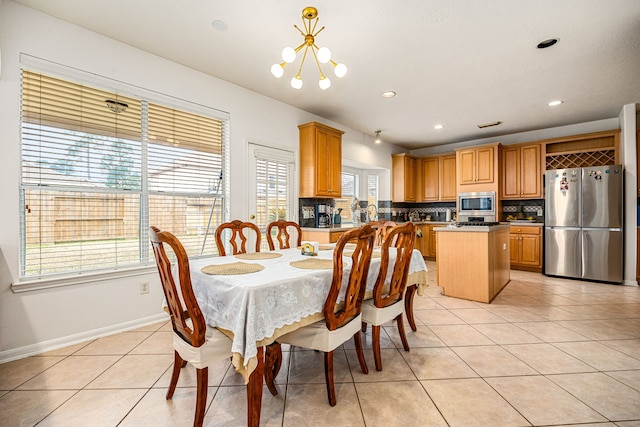 dining area with an inviting chandelier and light tile patterned floors