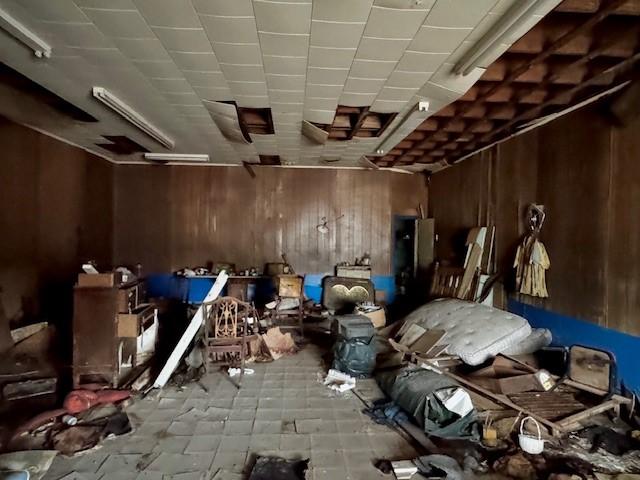 miscellaneous room featuring wood walls and light tile patterned floors