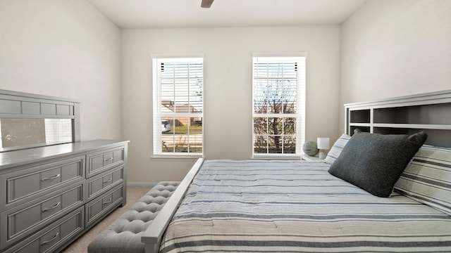 bedroom with carpet floors, multiple windows, and ceiling fan