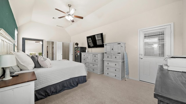 bedroom featuring ceiling fan, light carpet, and vaulted ceiling