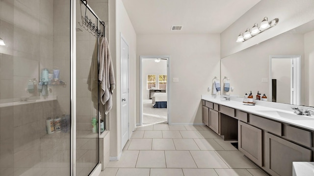 bathroom with tile patterned floors, vanity, and an enclosed shower