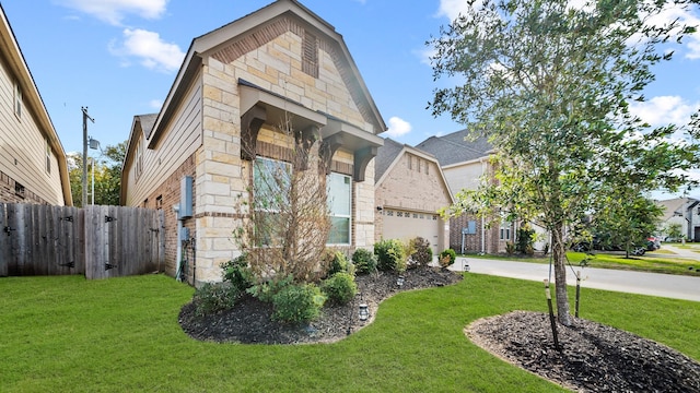 view of front of home featuring a front yard and a garage