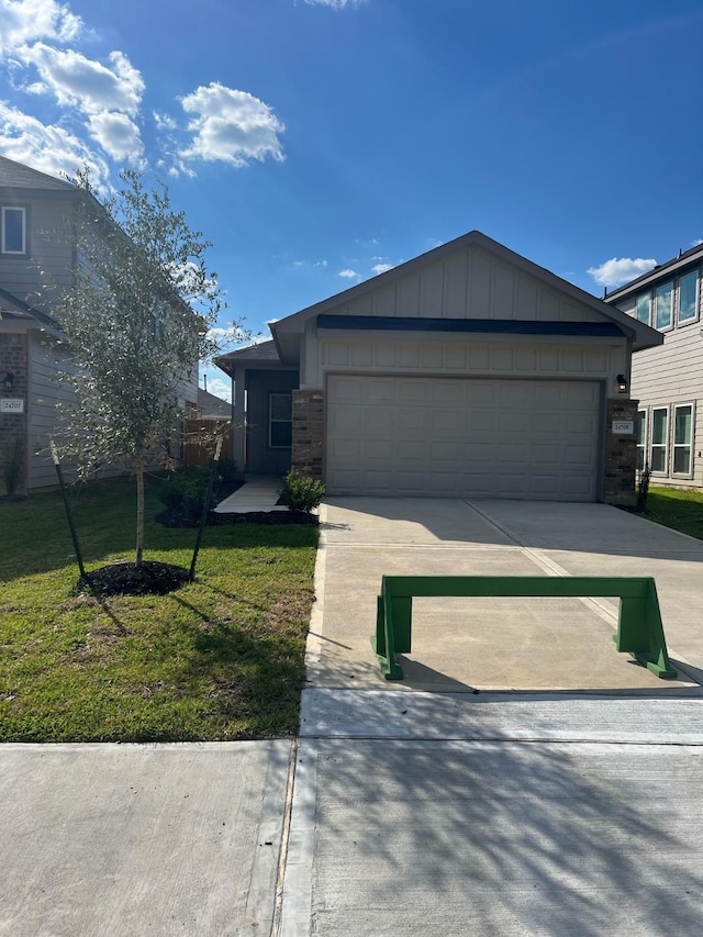 view of front of home with a garage and a front yard