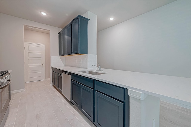 kitchen with backsplash, stainless steel appliances, blue cabinets, and sink