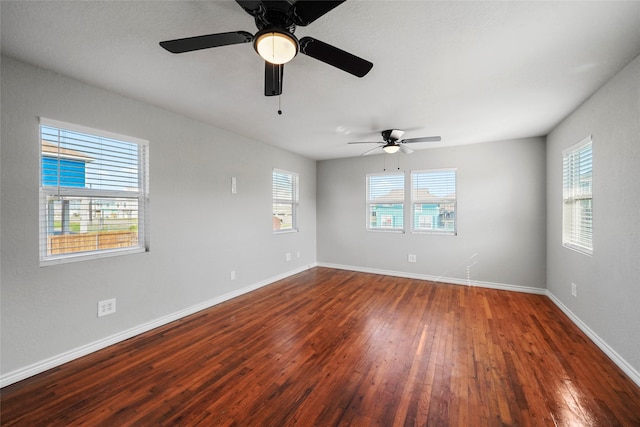 spare room featuring ceiling fan and dark wood-type flooring