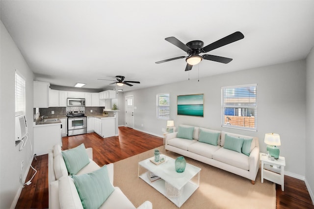 living room with ceiling fan, sink, and dark hardwood / wood-style floors