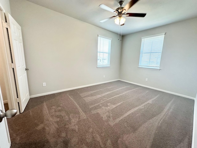 carpeted empty room featuring ceiling fan