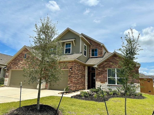 craftsman inspired home featuring a front yard and a garage