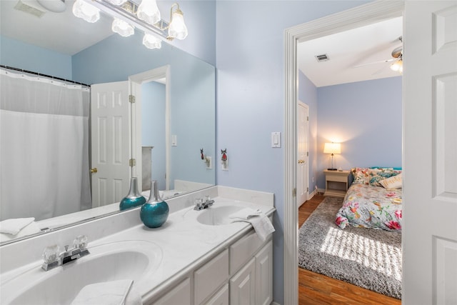 bathroom featuring wood-type flooring, vanity, and ceiling fan