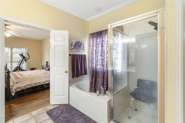 bathroom with tile patterned flooring, ceiling fan, and plus walk in shower