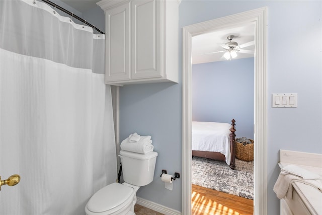 bathroom featuring ceiling fan, wood-type flooring, and toilet