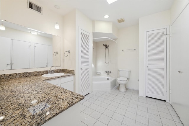 bathroom featuring tile patterned flooring, vanity, and toilet