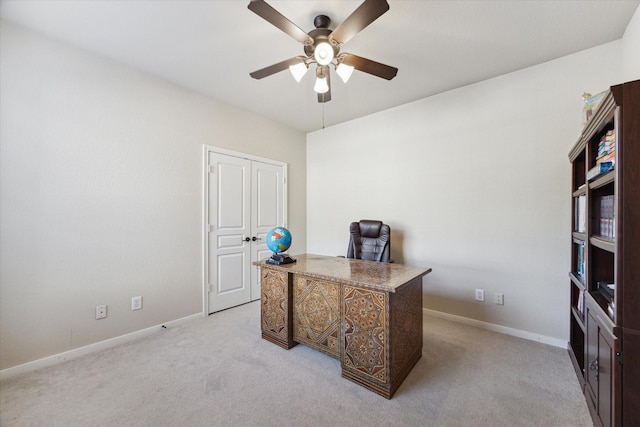 carpeted office space with ceiling fan