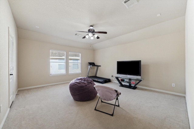 living area featuring ceiling fan, light colored carpet, and lofted ceiling