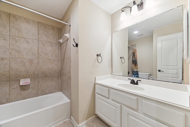 full bathroom with tile patterned flooring, vanity, toilet, and tiled shower / bath