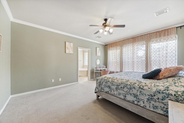 carpeted bedroom with ceiling fan, ensuite bathroom, and ornamental molding