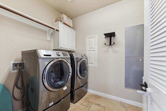 laundry area with cabinets and washing machine and clothes dryer