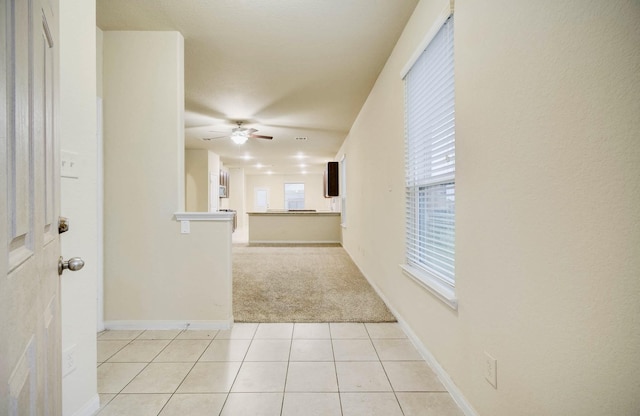 hallway with light tile patterned floors