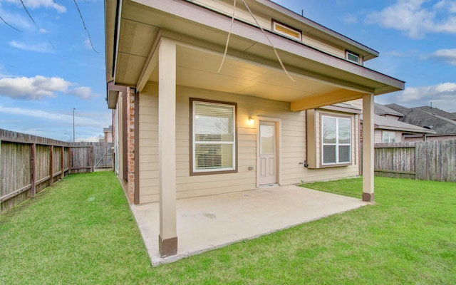 rear view of house featuring a patio area and a yard