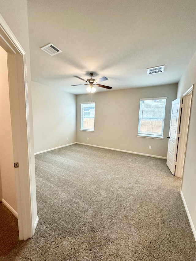 spare room featuring carpet flooring and ceiling fan