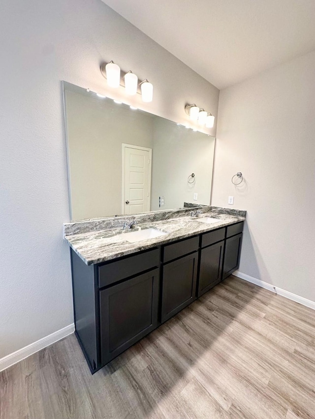 bathroom with hardwood / wood-style floors and vanity