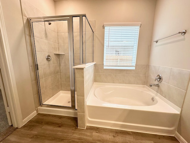 bathroom featuring hardwood / wood-style flooring and independent shower and bath