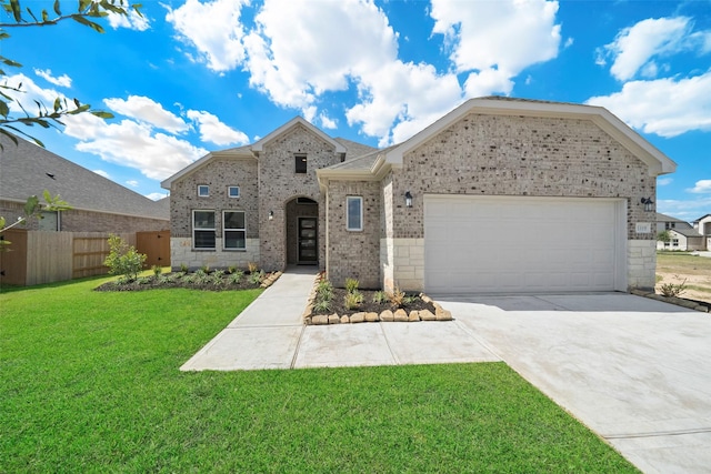 view of front of property featuring a garage and a front lawn