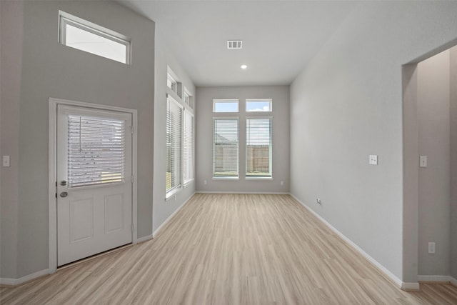 interior space with a wealth of natural light and light hardwood / wood-style floors