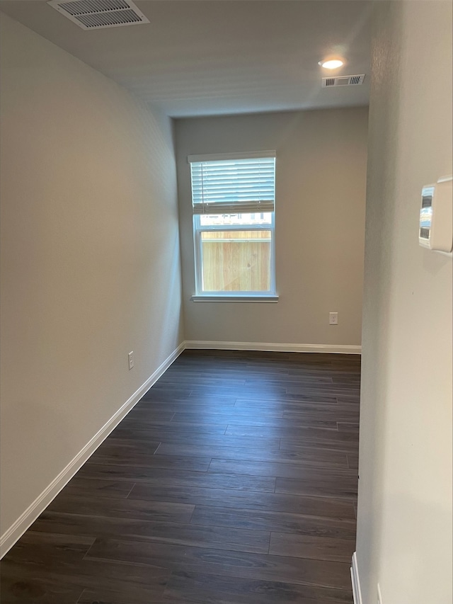 empty room featuring dark hardwood / wood-style flooring