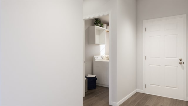 hall with hardwood / wood-style floors and washer / dryer