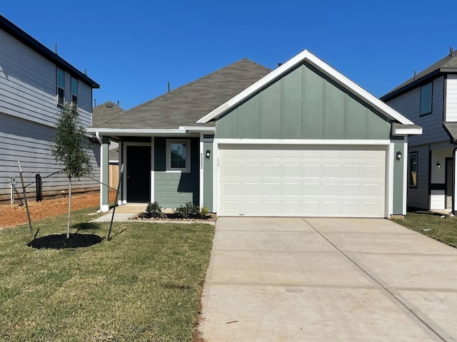 view of front of house featuring a garage and a front lawn