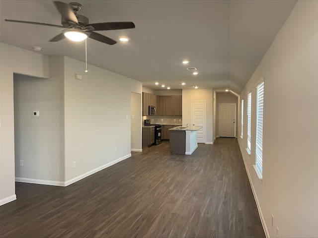 unfurnished living room with dark hardwood / wood-style floors and ceiling fan