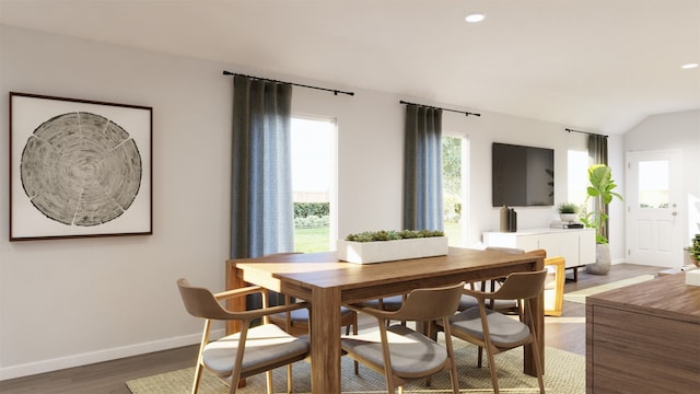 dining room with dark wood-type flooring and lofted ceiling