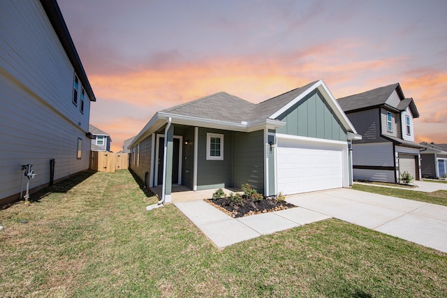 view of front of property featuring a lawn, fence, board and batten siding, concrete driveway, and an attached garage