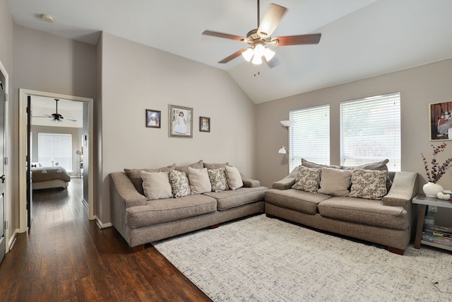 living room featuring dark hardwood / wood-style flooring, vaulted ceiling, and ceiling fan