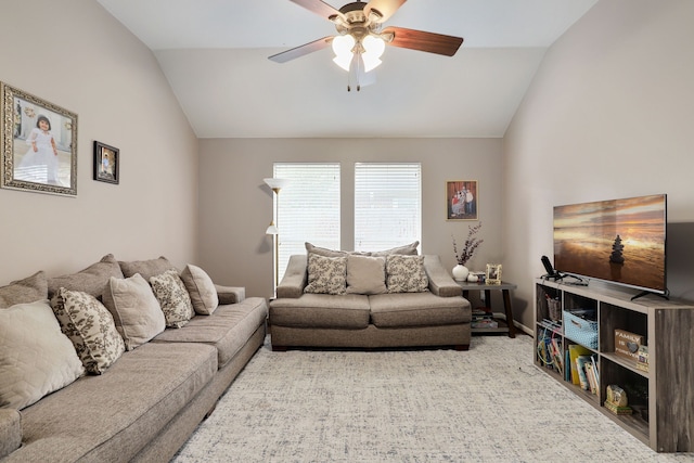 living room with ceiling fan, lofted ceiling, and light carpet