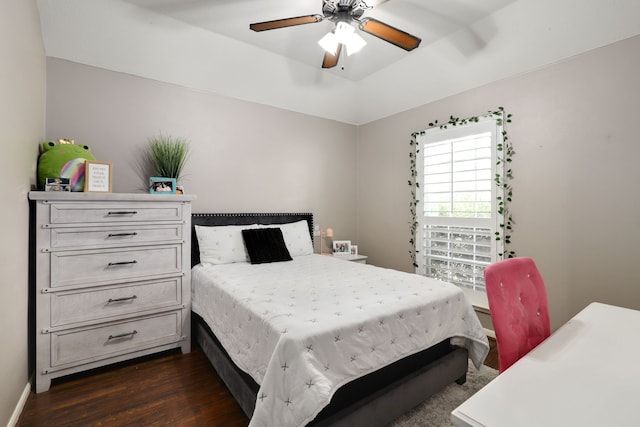 bedroom with dark hardwood / wood-style floors and ceiling fan