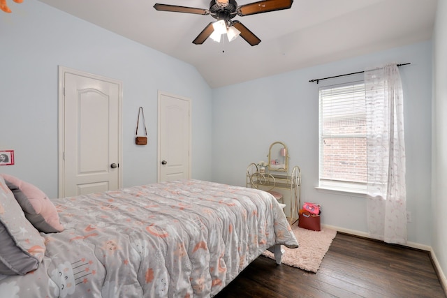 bedroom featuring ceiling fan, dark hardwood / wood-style flooring, and vaulted ceiling