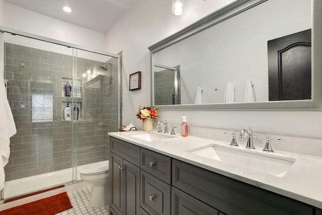 bathroom with tile patterned floors, toilet, vanity, and walk in shower