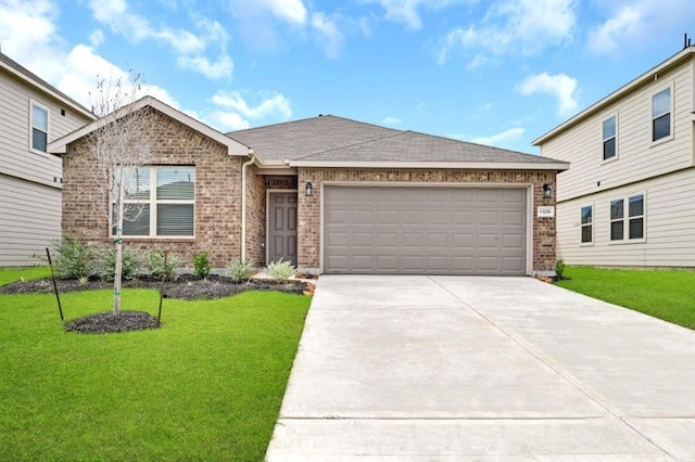 view of front of home with a garage and a front yard